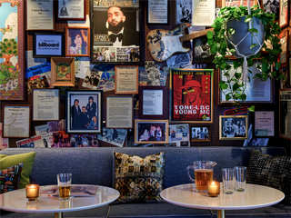 A collage of musical memorabilia on a wall at Hotel Ziggy